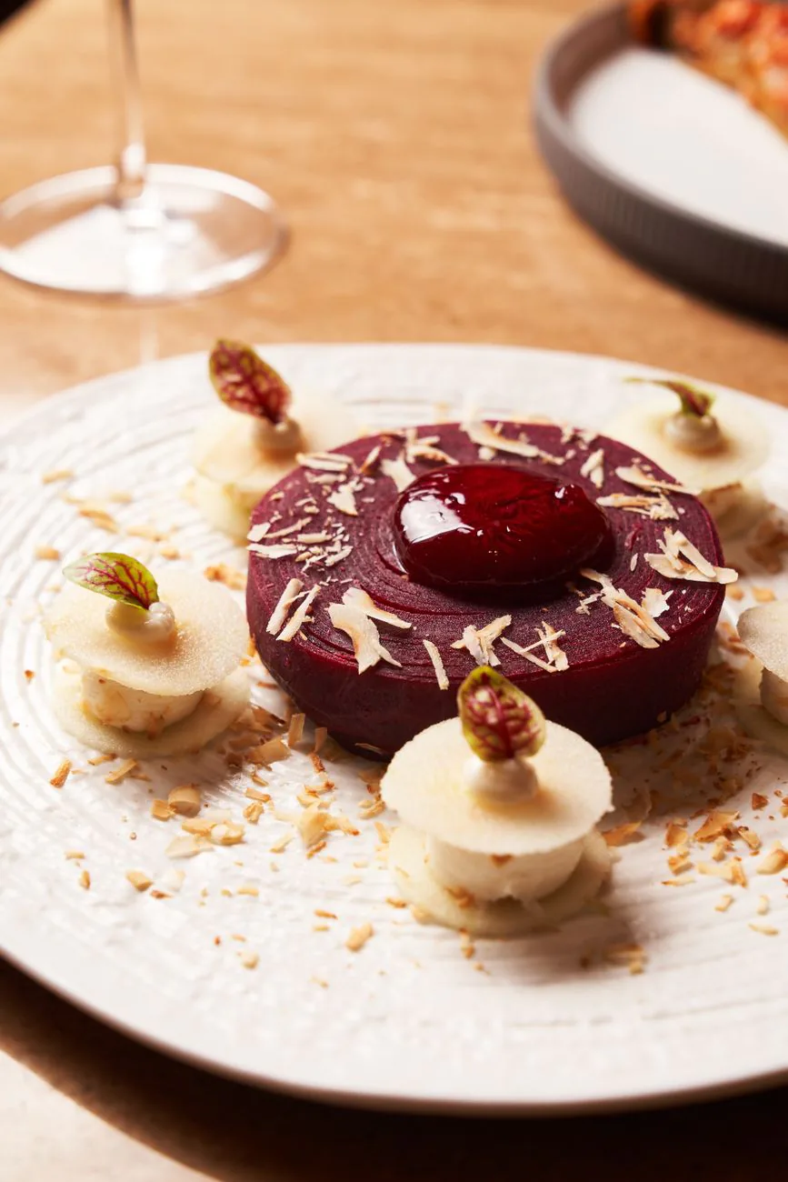 Plated dessert with berry and cream layers